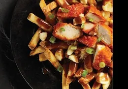 Poutine topped with chicken and gravy
